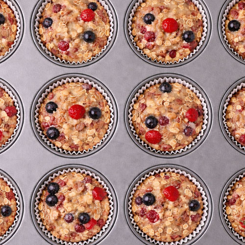 Berry oatmeal muffins in a muffin tin.