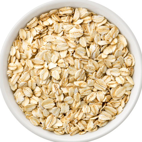 Bowl filled with uncooked rolled oats.