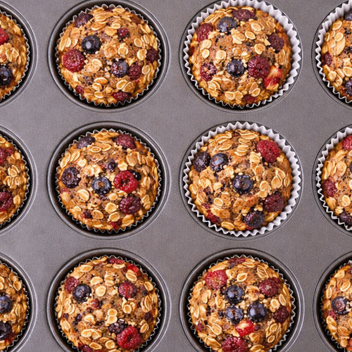 Berry oatmeal muffins in baking tray, ready to serve.