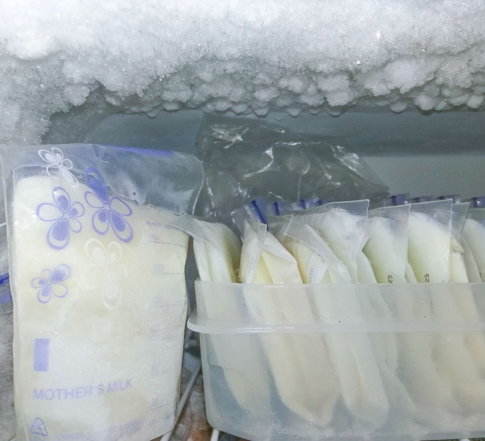 Frozen breast milk bags stored in freezer