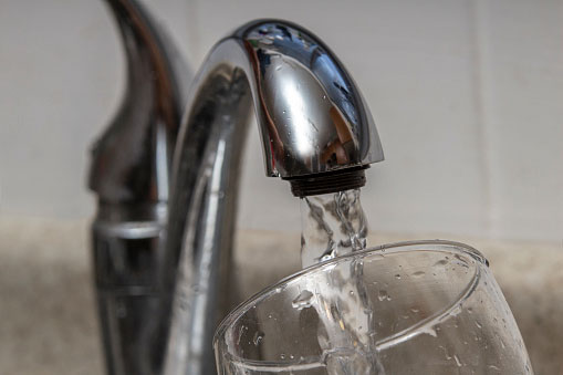 water is poured into a faucet