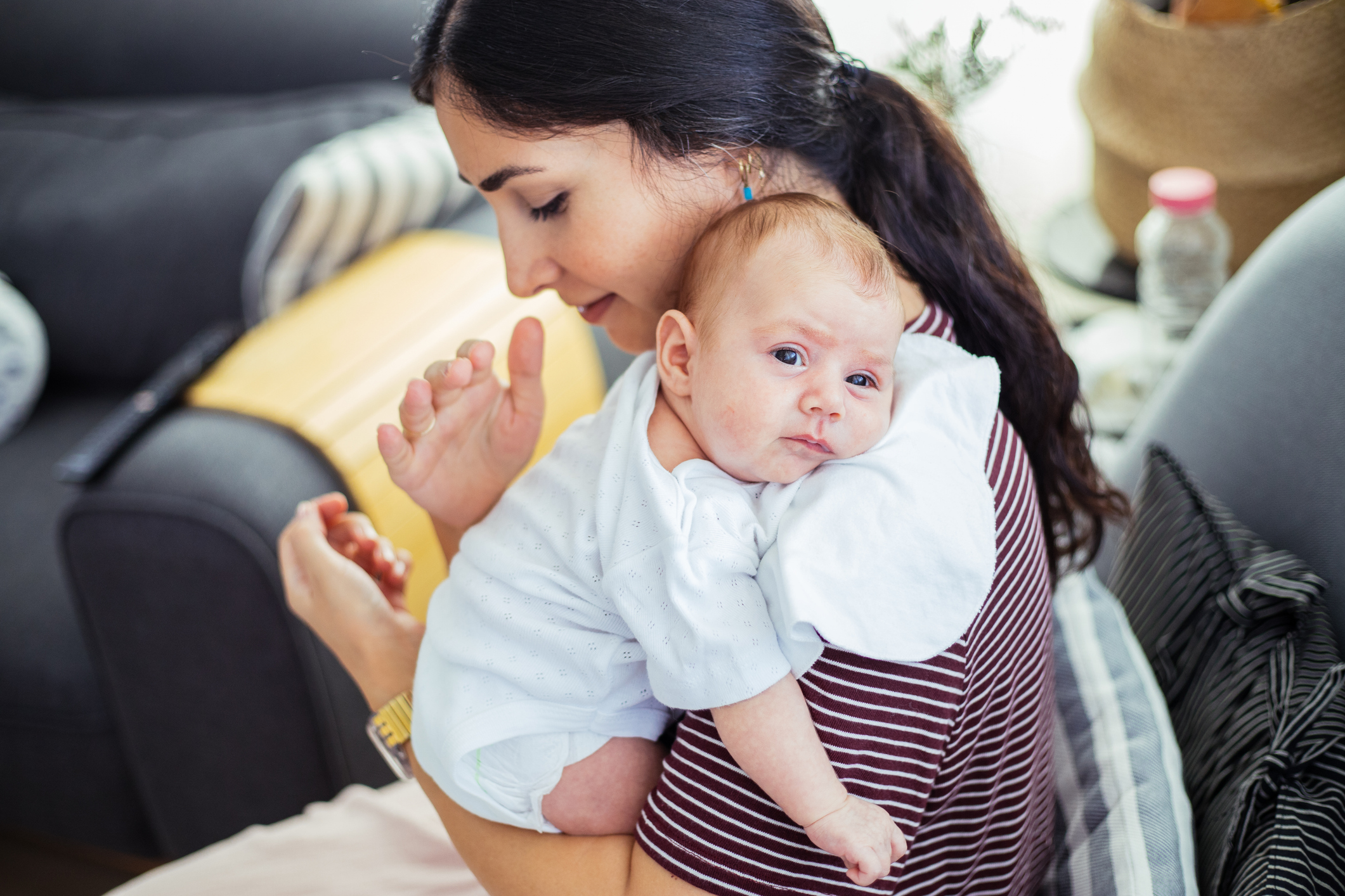 Mother holding the baby over her shoulder for burping