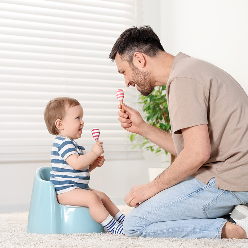 Dad with toddler while potty time